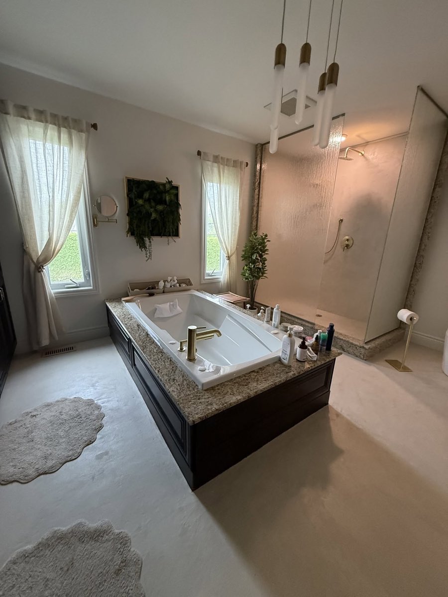 Après les travaux, la même salle de bain terminée, plancher continu sans joint